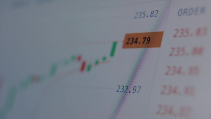 A close-up of a digital stock market chart on a screen displaying real-time, fluctuating share prices
