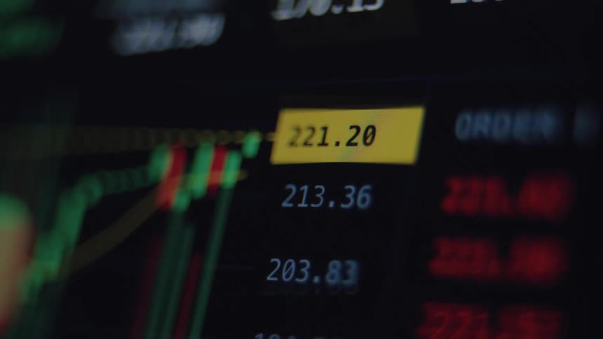 Extreme close-up of a digital stock market display showing volatile price fluctuations in real-time
