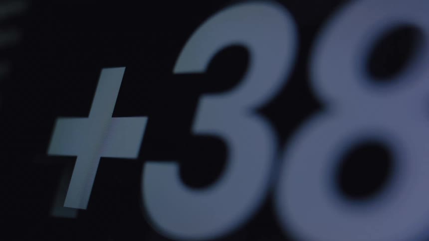 A macro, out-of-focus shot of a digital counter with a plus sign rapidly increasing on a dark screen
