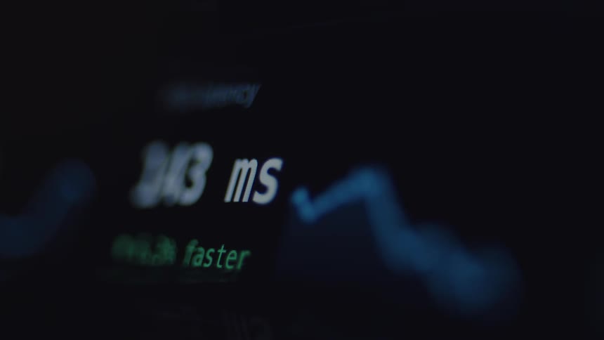 An out-of-focus digital display shows a fluctuating latency measurement in milliseconds next to a blue line graph