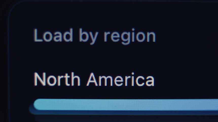 Extreme close-up macro shot of a digital screen with a progress bar loading the North America region