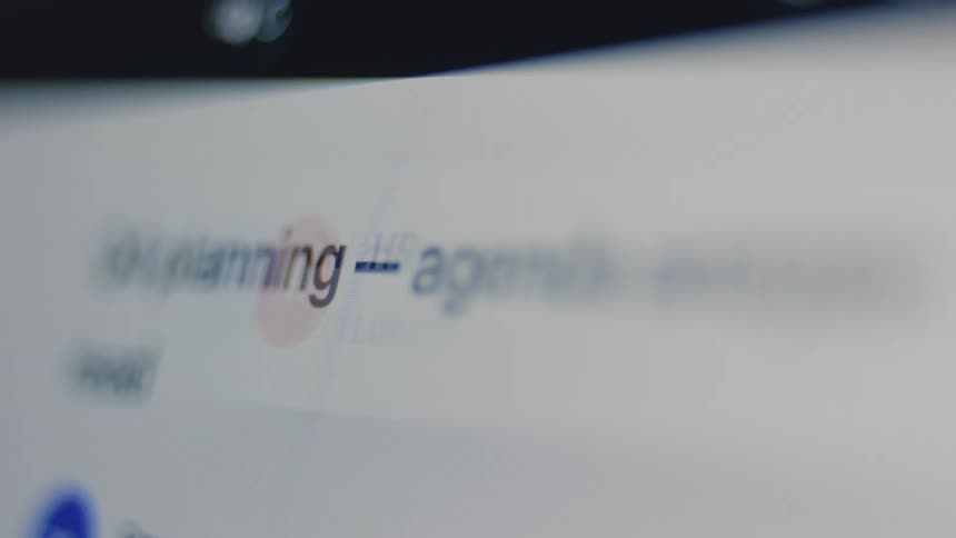 Macro close-up shot of a digital inbox scrolling through a fast-paced stream of emails and notifications on a computer screen