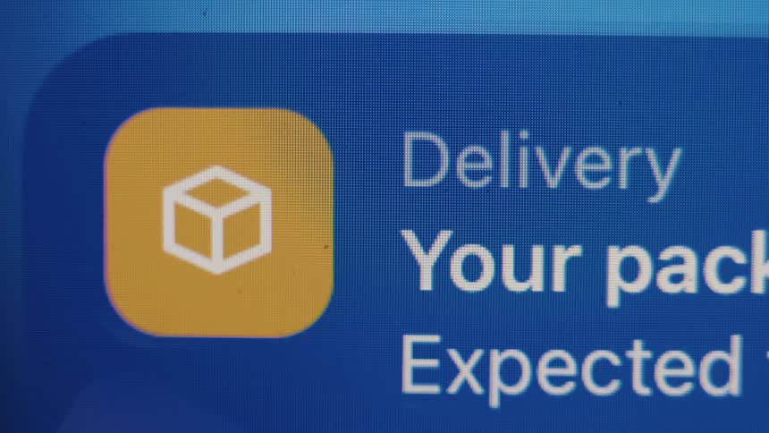 A close-up shot of a digital screen displaying a notification for an expected package delivery