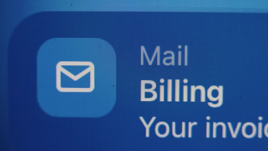 A close-up view of a digital screen shows an email notification about billing and an invoice