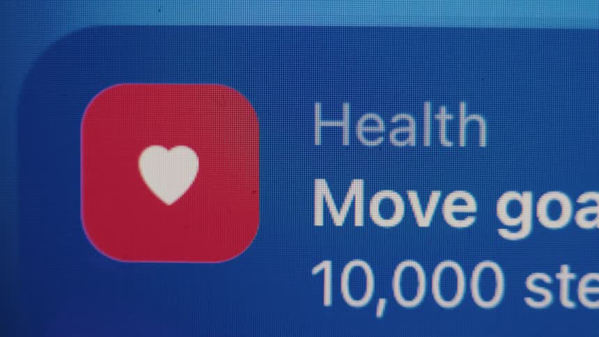 Close-up of a smartphone screen showing a health app notification for reaching a 10,000 step move goal