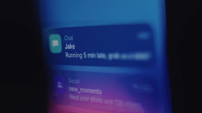A macro close-up of a smartphone screen shows various push notifications for social media, banking, and messages appearing