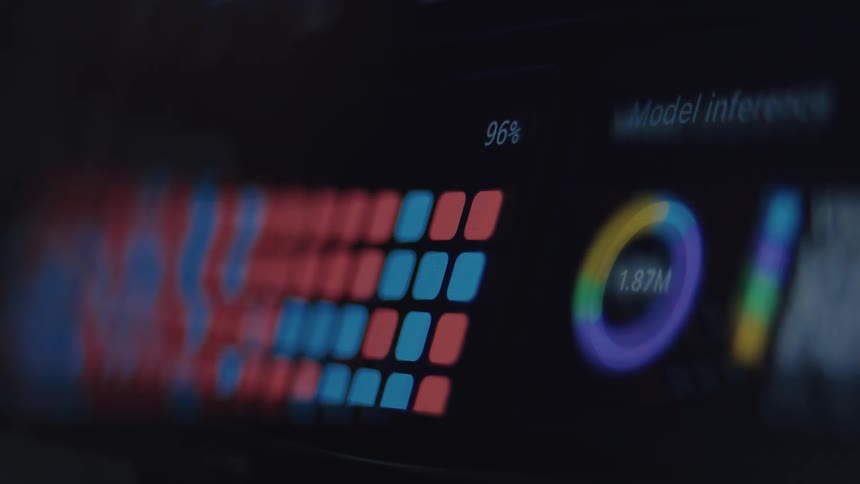 A futuristic computer screen displays an out-of-focus graphical user interface showing data processing and model inference analytics