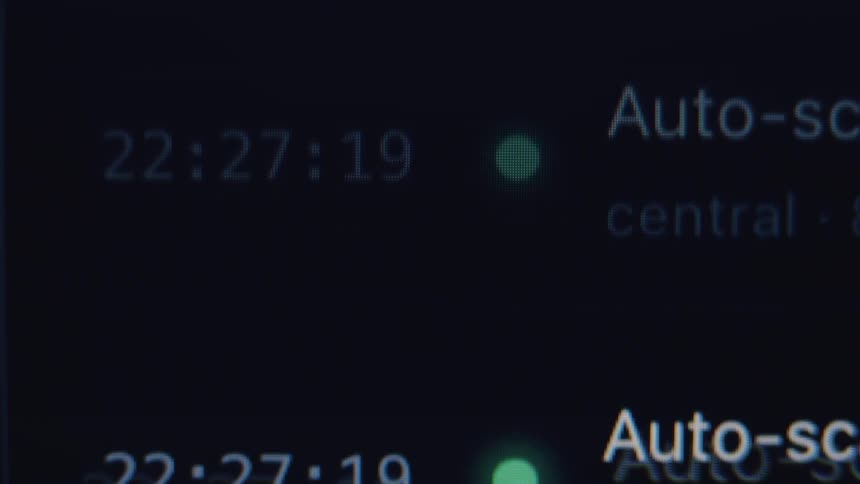 Close up of a real-time computer log file scrolling on a screen showing system events and status updates