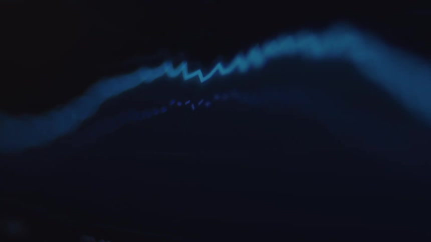 A close-up of a fluctuating blue waveform representing data on a dark screen