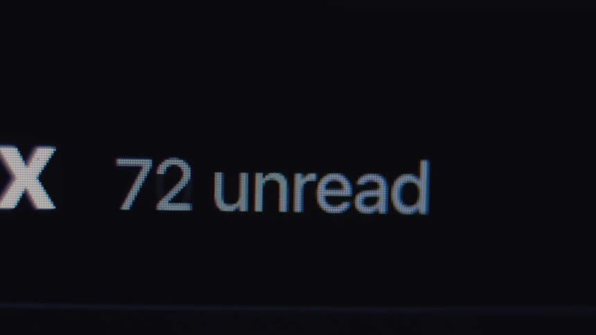 A close-up of a computer screen shows the number of unread messages in an inbox rapidly increasing
