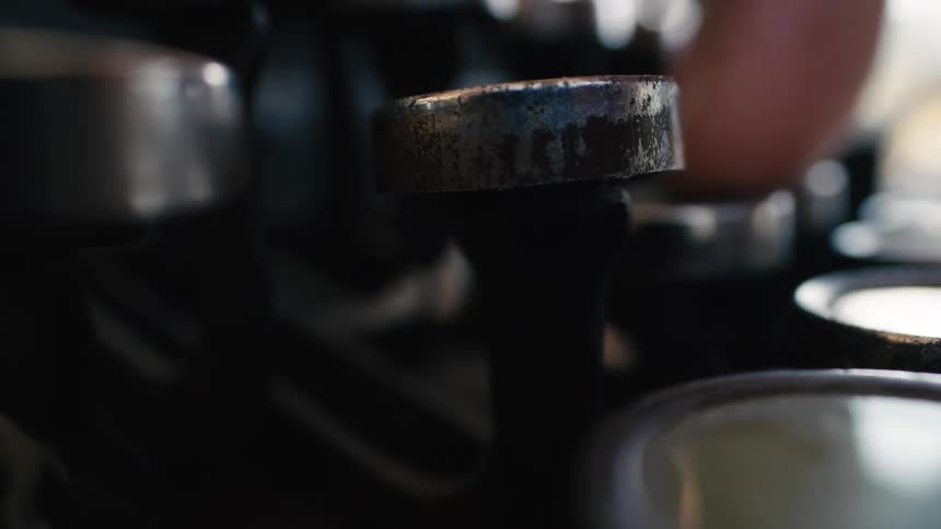 Extreme close-up of fingers typing on the dusty, worn keys of a retro typewriter