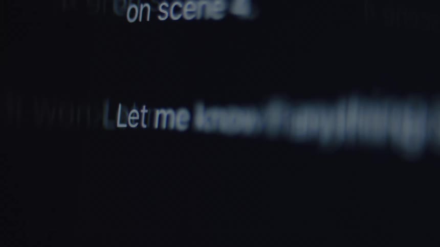Close up of someone typing the end of a message on a dark computer screen