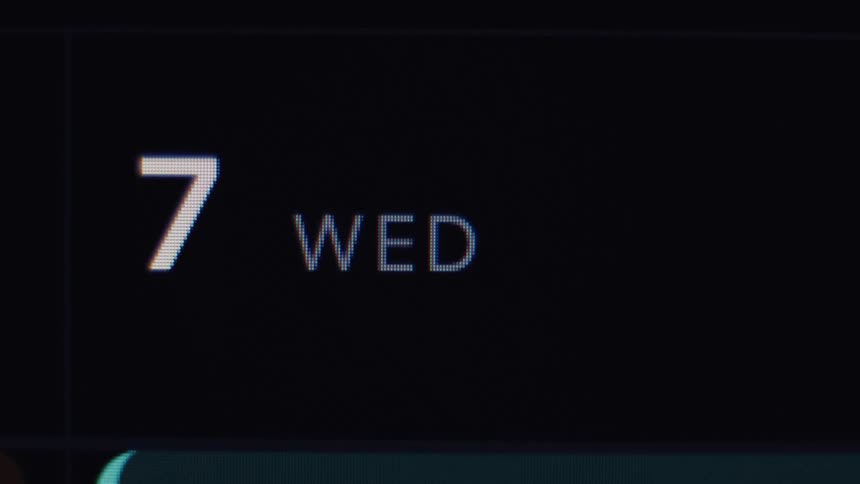 Macro close-up of a digital calendar on a screen showing the date as Wednesday the 7th