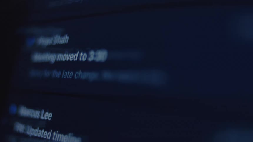 An angled, close-up shot of a user quickly scrolling through a cluttered inbox of digital messages