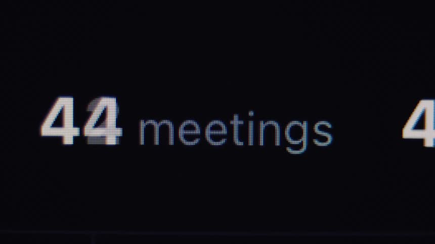 A close-up of a digital counter showing the number of meetings rapidly increasing on a screen