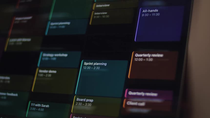 An animated digital calendar fills up with various color-coded meetings and appointments, indicating a busy work schedule