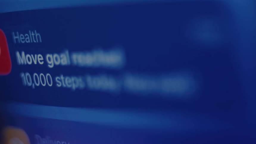 An overwhelming stream of digital notifications from various apps scrolls endlessly on a glowing blue screen, illustrating the constant demands of modern life
