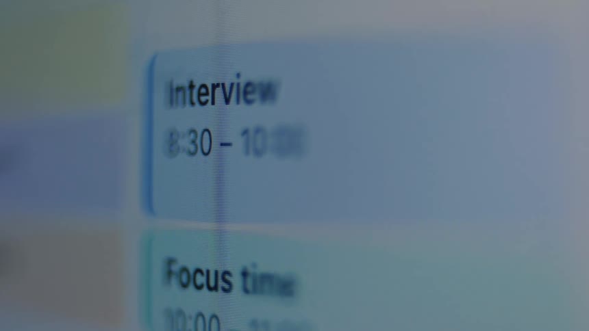 A close-up shot of a digital calendar displaying a scheduled interview and other work appointments