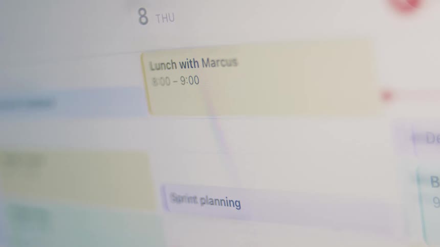A close-up shot of a user's digital calendar filling up with meetings like 'Lunch with Marcus' and 'Vendor Demo'