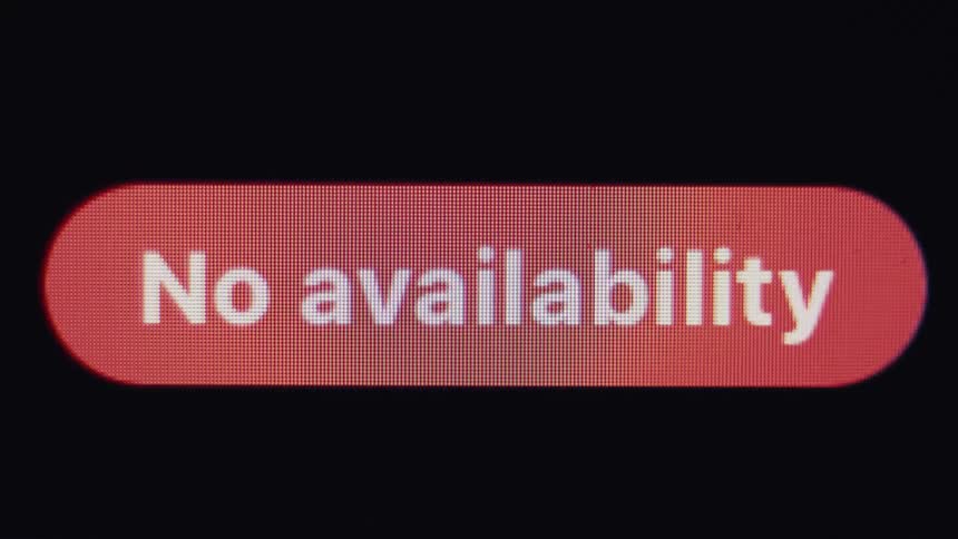 A close-up macro shot of a digital screen displaying a red 'No availability' notification