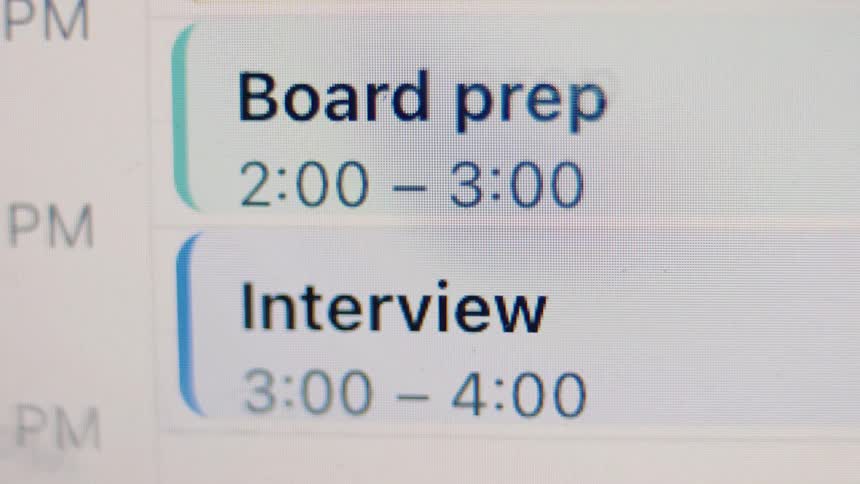 A close-up of a digital calendar shows back-to-back afternoon meetings for board prep and an interview