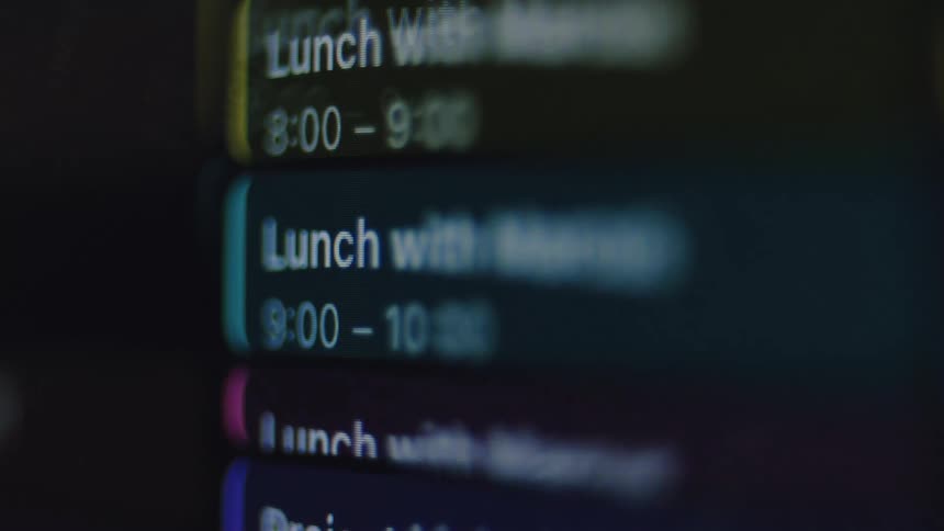 A macro shot shows a digital calendar with appointments scrolling on a dark screen