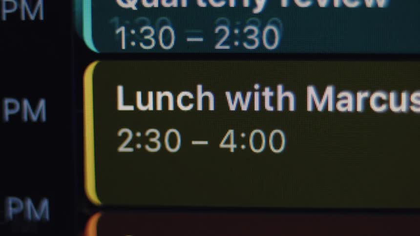 A close-up of a digital calendar scrolls to reveal a 'Lunch with Marcus' appointment