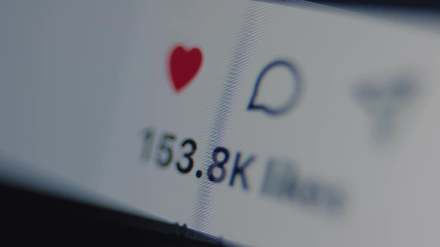 A macro view of a social media post's like counter rapidly increasing as it goes viral