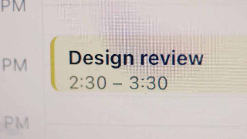 Close-up of a digital calendar on a screen showing a 'Design review' appointment scheduled for the afternoon