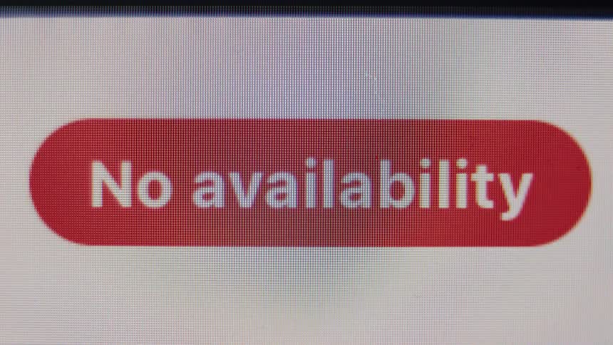 A close-up of a red 'No availability' button displayed on a pixelated digital screen