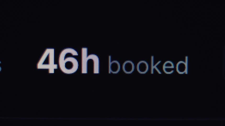 A close-up of a digital counter showing the rapidly increasing number of hours being booked on a screen