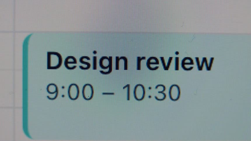A close-up shot of a digital calendar showing a scheduled 'Design review' meeting