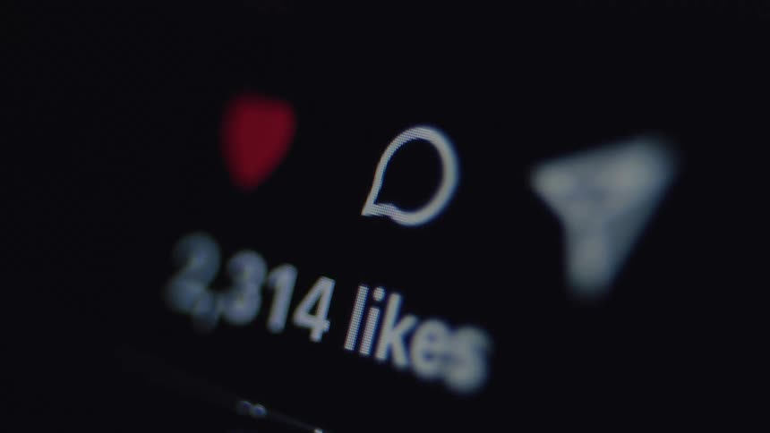 A close-up shot of a social media like counter rapidly increasing as a post goes viral on a smartphone screen