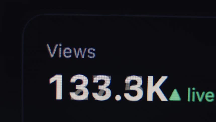 A live view counter on a digital screen rapidly increases, showing a video going viral and reaching over a million views