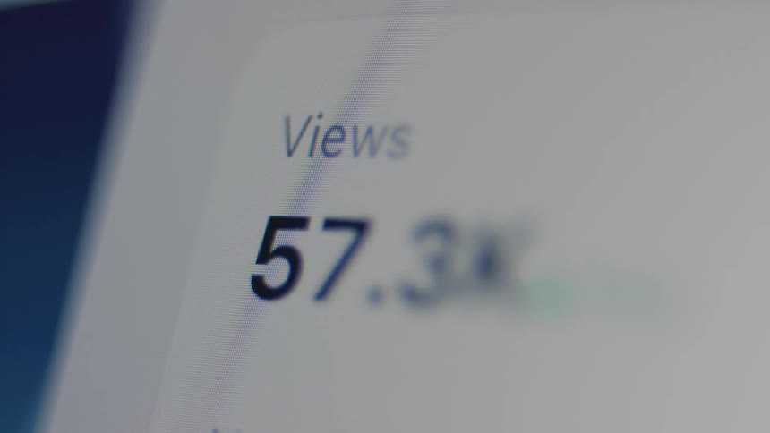 A social media post's view count rapidly increases, showing the content going viral on a digital screen