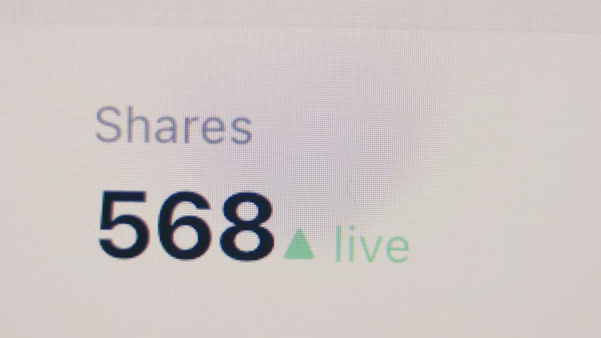 A live counter on a screen shows the number of shares rapidly increasing, symbolizing viral content and social media engagement