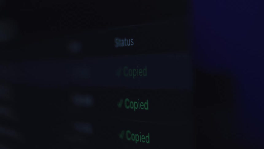 Close-up of a dark user interface on a computer screen showing the successful status of a file copying process