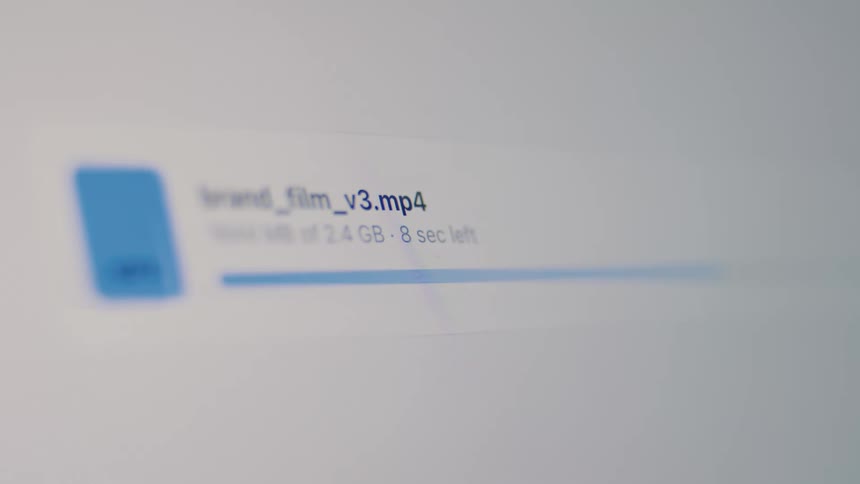 A close-up view of a large video file being uploaded, showing the progress bar and time remaining on a computer screen