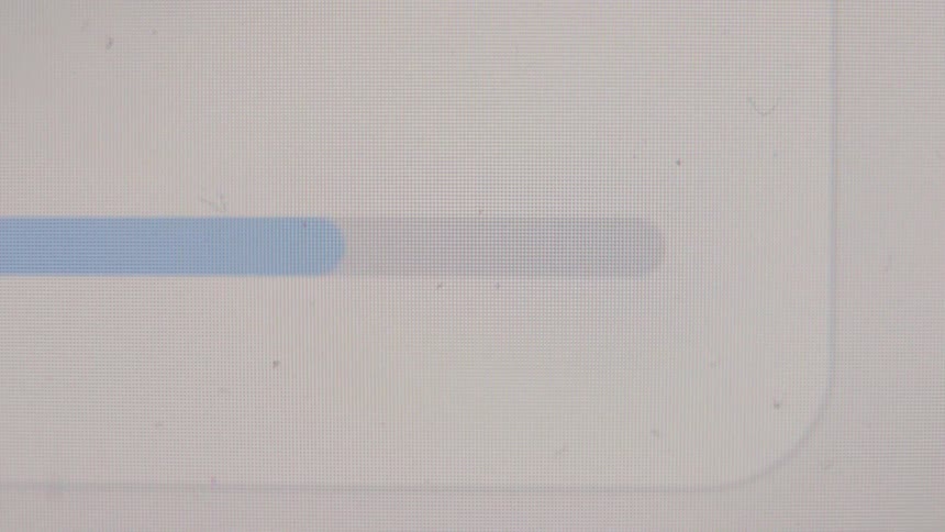 A close-up shot of a blue progress bar loading or downloading on a computer screen