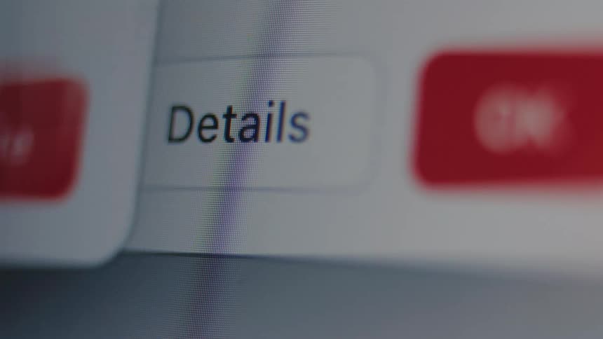 A macro shot shows a focus pull onto a white 'Details' button on a digital interface
