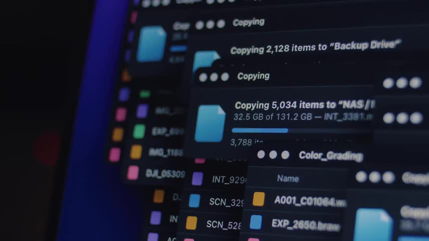 Close-up of a computer screen showing the progress bar of a large file transfer to a network-attached storage drive