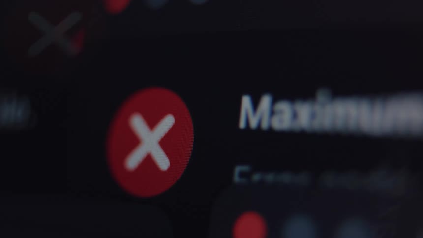 A macro shot shows a flashing red X symbol and the word 'Maximum' on a computer screen, indicating a digital error or limit reached