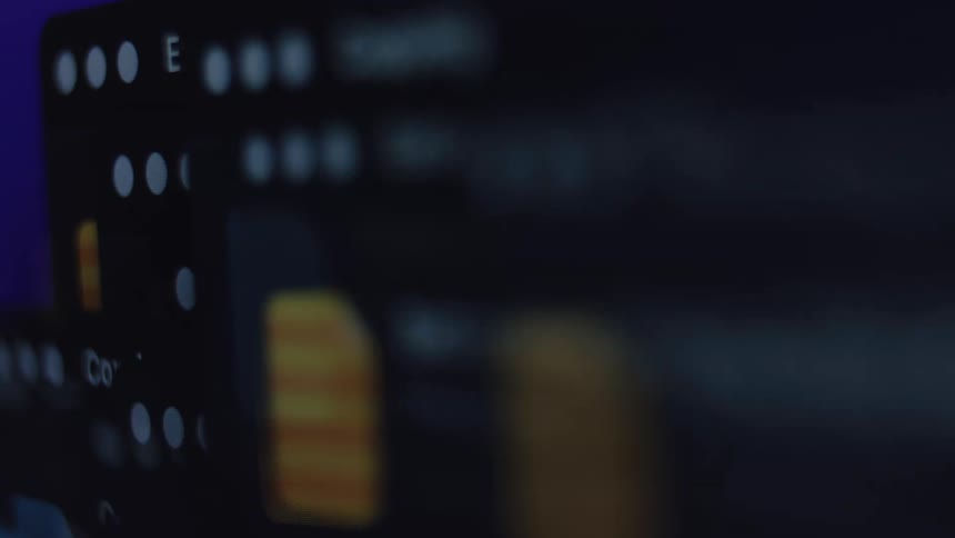 A close-up, out-of-focus time-lapse of data being extracted and copied on a computer screen with a dark mode interface