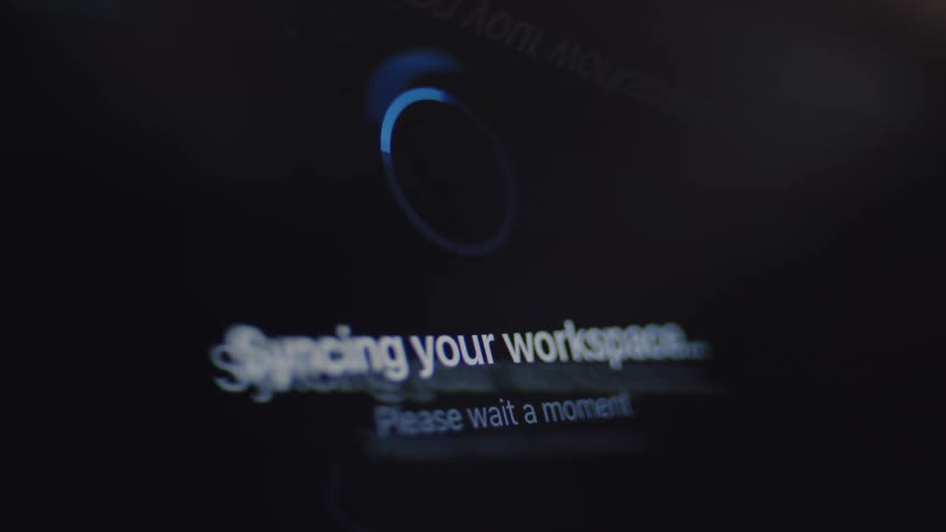 A digital screen shows a circular loading animation and a sequence of text messages, from connecting and authenticating to syncing and finally a success confirmation