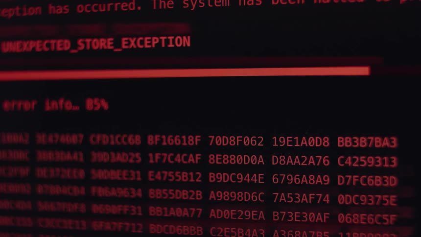 A close-up of a computer screen showing a red critical system error message and a progress bar before restarting