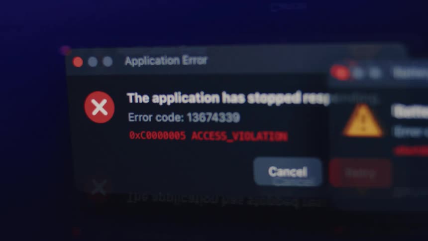 Close up of an application error message on a computer screen indicating a system crash or software failure