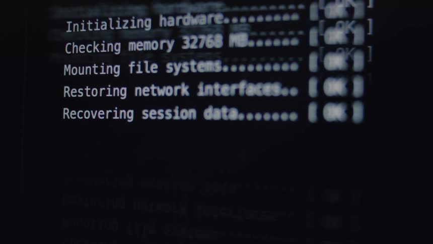 A computer screen displays the command-line interface of a system restore process, showing each step from hardware initialization to completion