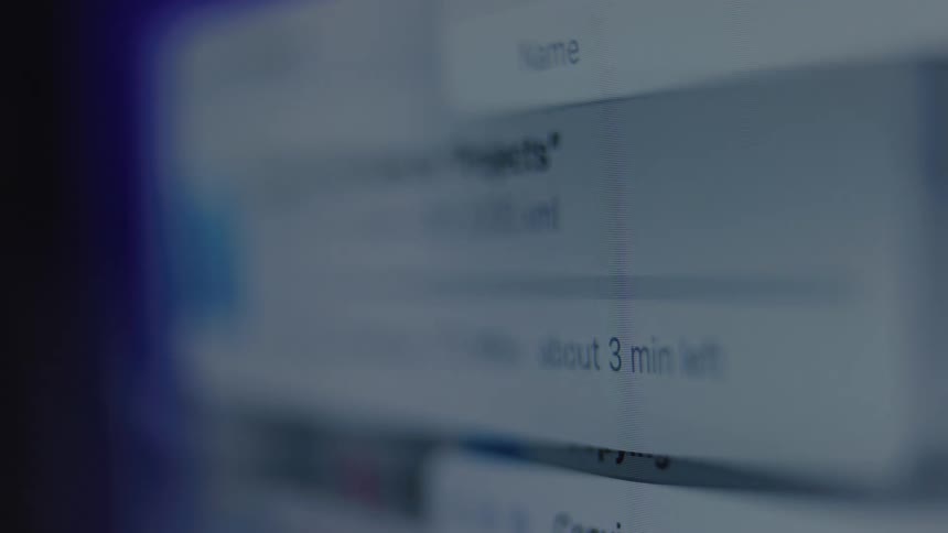 A detailed macro shot of a computer screen showing the process of files being copied and organized into folders