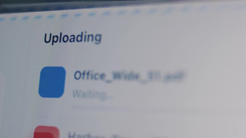 Files being uploaded to cloud storage with a progress bar showing the transfer status on a screen