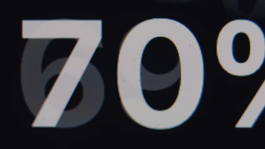 A digital percentage counter quickly loads up to ninety-nine percent on a screen, followed by a checkmark indicating completion